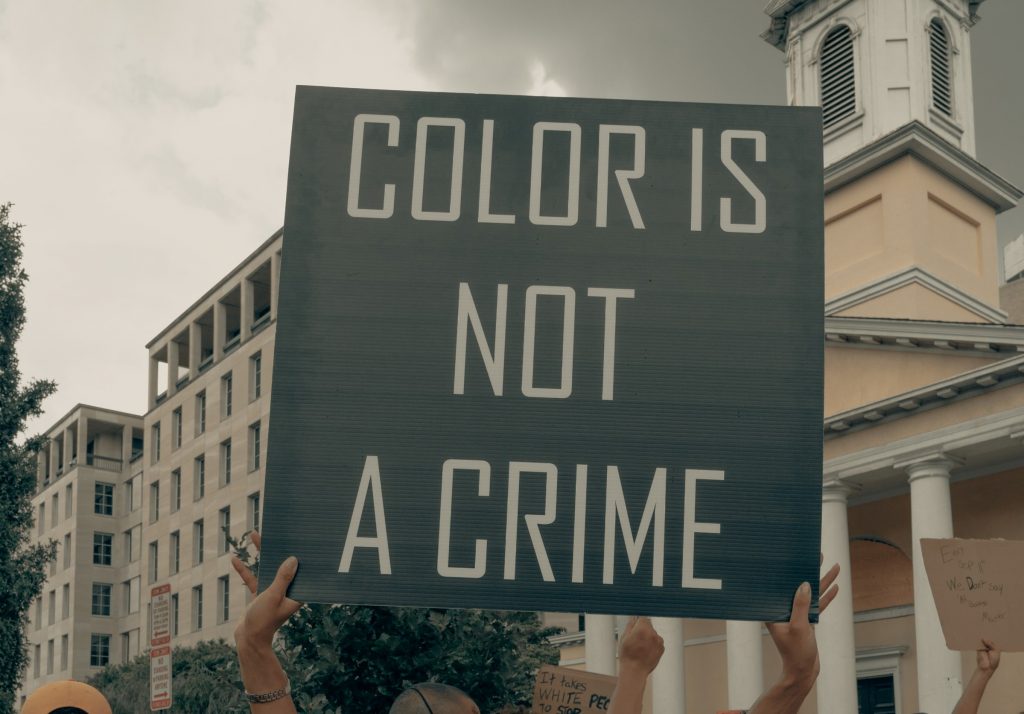 Protest sign on ethnic discrimination. Not necessarily about the environment.