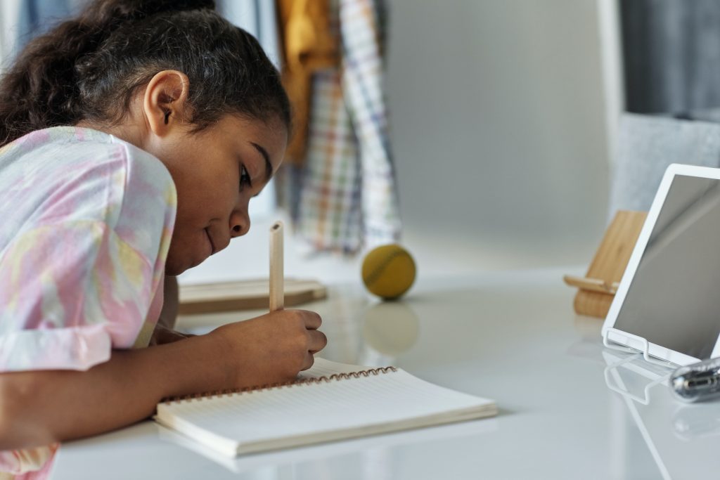 A child accessing basic education at home.