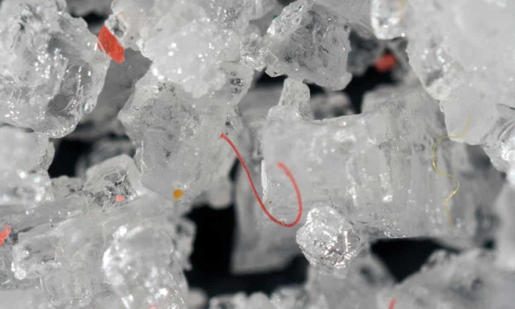 Tiny fragments and filaments of plastic in table salt crystals.