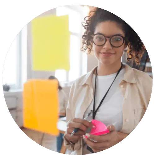 A woman with sticky notes. Thrivable voting focuses on business.