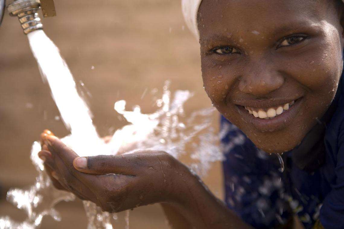 Marida Sittou, 14, drinks from a district water point in a southern suburb of Zinder, capital of Zinder Region, Southern Niger.